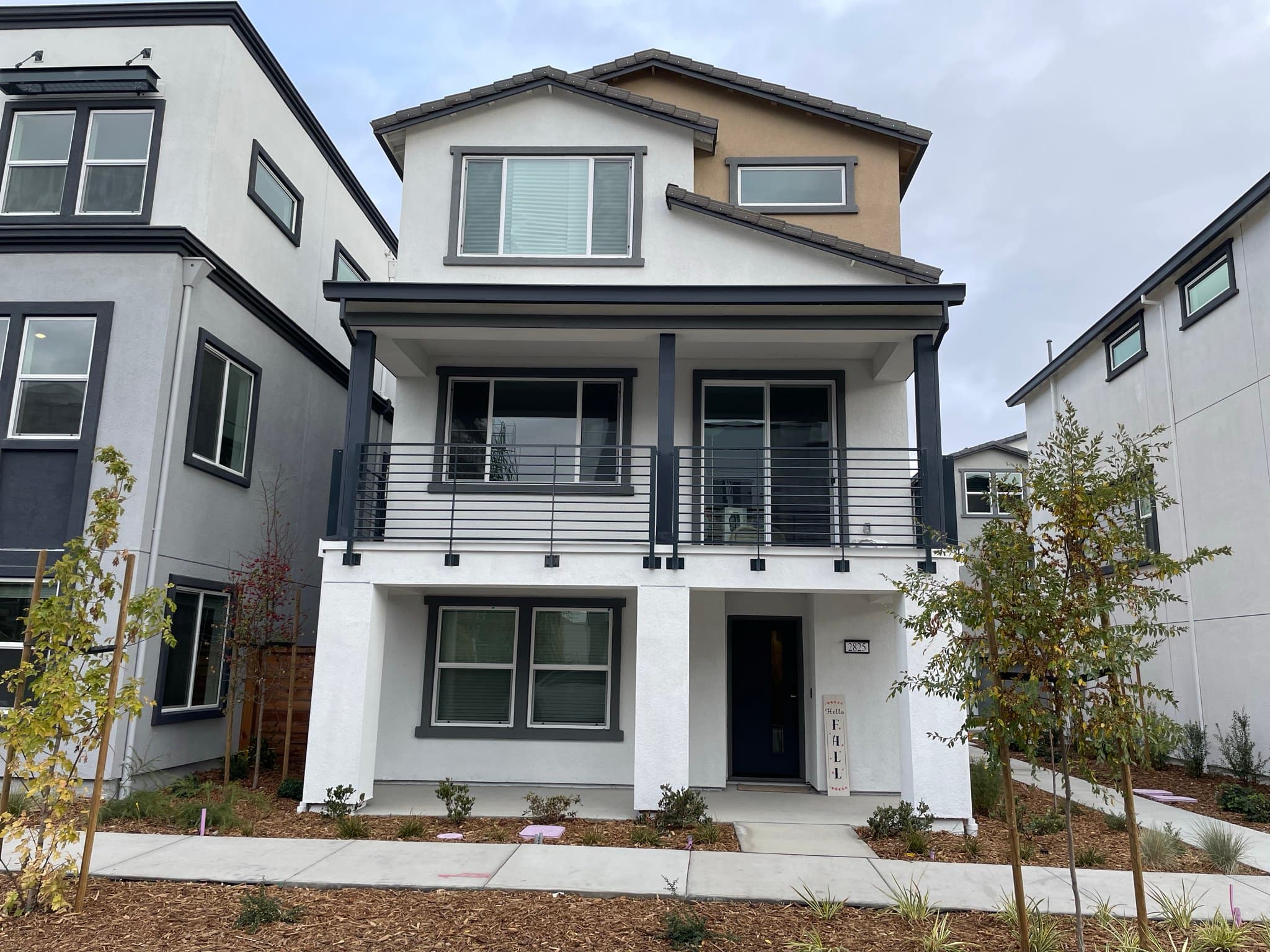 Front exterior of 2825 Crusader St — three-story home with covered porch and balcony